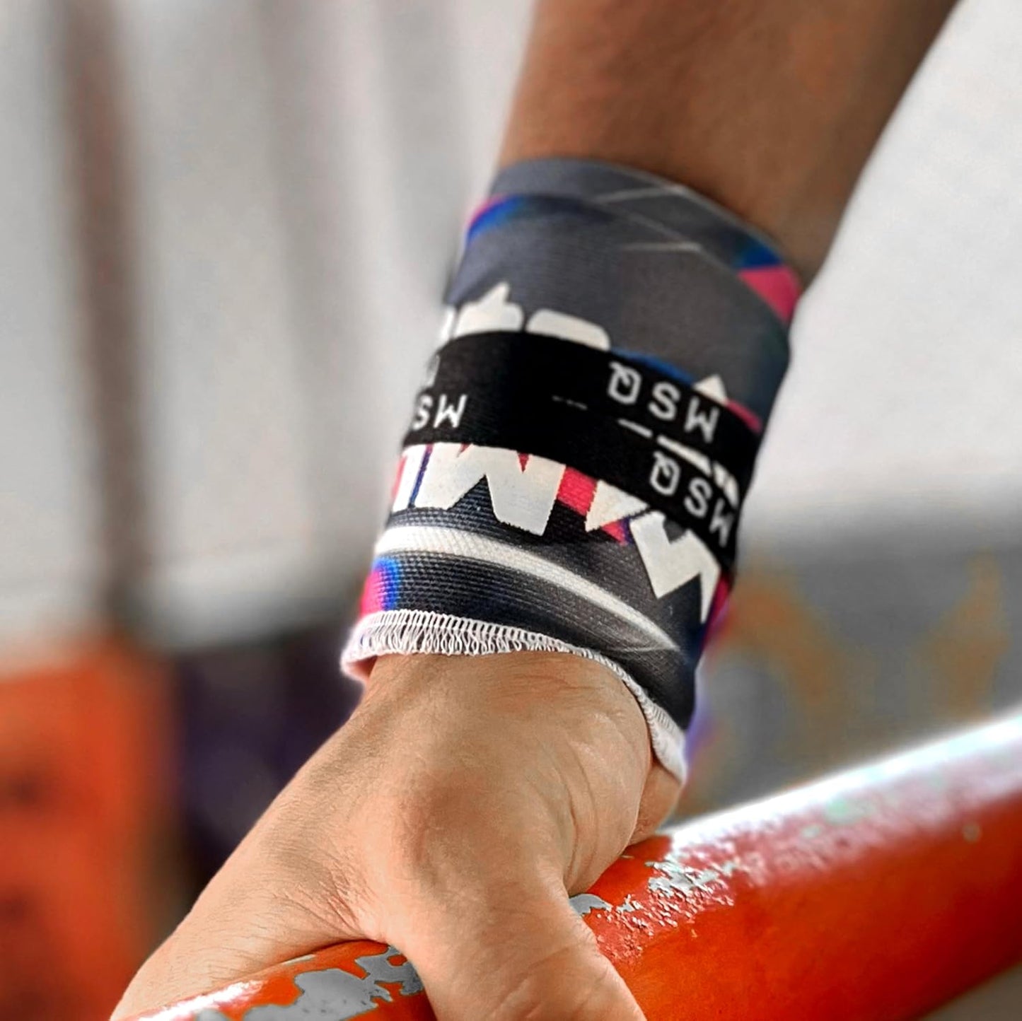Close-up of a hand wearing Gripzora Urban Streetwear wrist wraps, providing crucial stability and support during heavy lifts and calisthenics training.