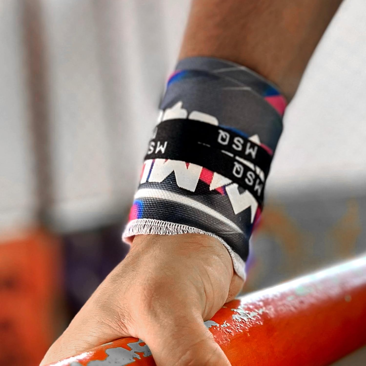 Close-up of a hand wearing Gripzora Urban Streetwear wrist wraps, providing crucial stability and support during heavy lifts and calisthenics training.