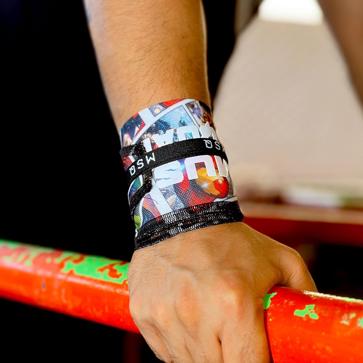 Close-up of a hand wearing Gripzora Primal Matrix wrist wraps, providing crucial stability and support during heavy lifts and calisthenics training.