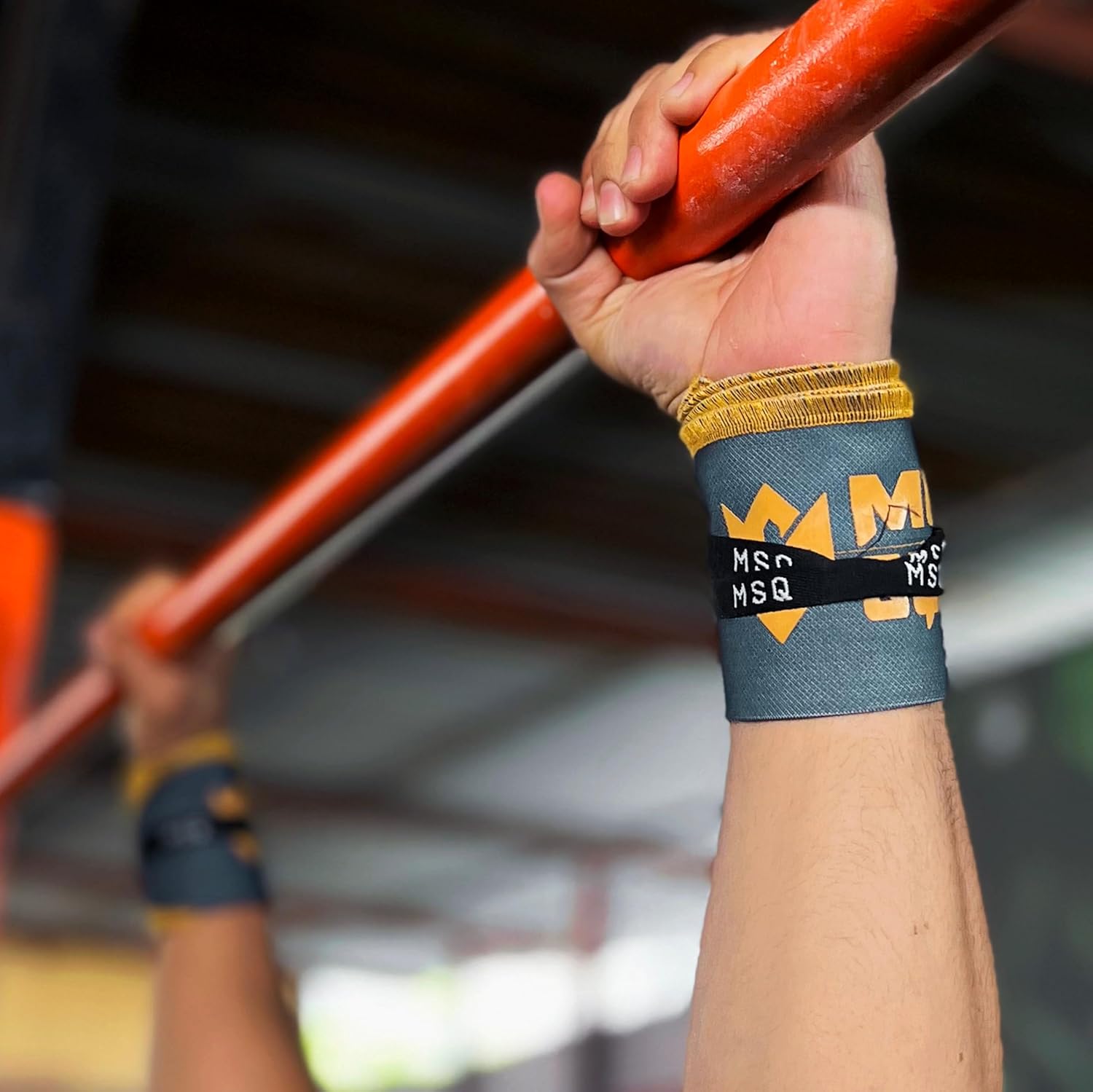 Close-up of a hand gripping a pull-up bar, wearing Gripzora Urban Grime wrist wraps for enhanced stability during calisthenics and weightlifting.