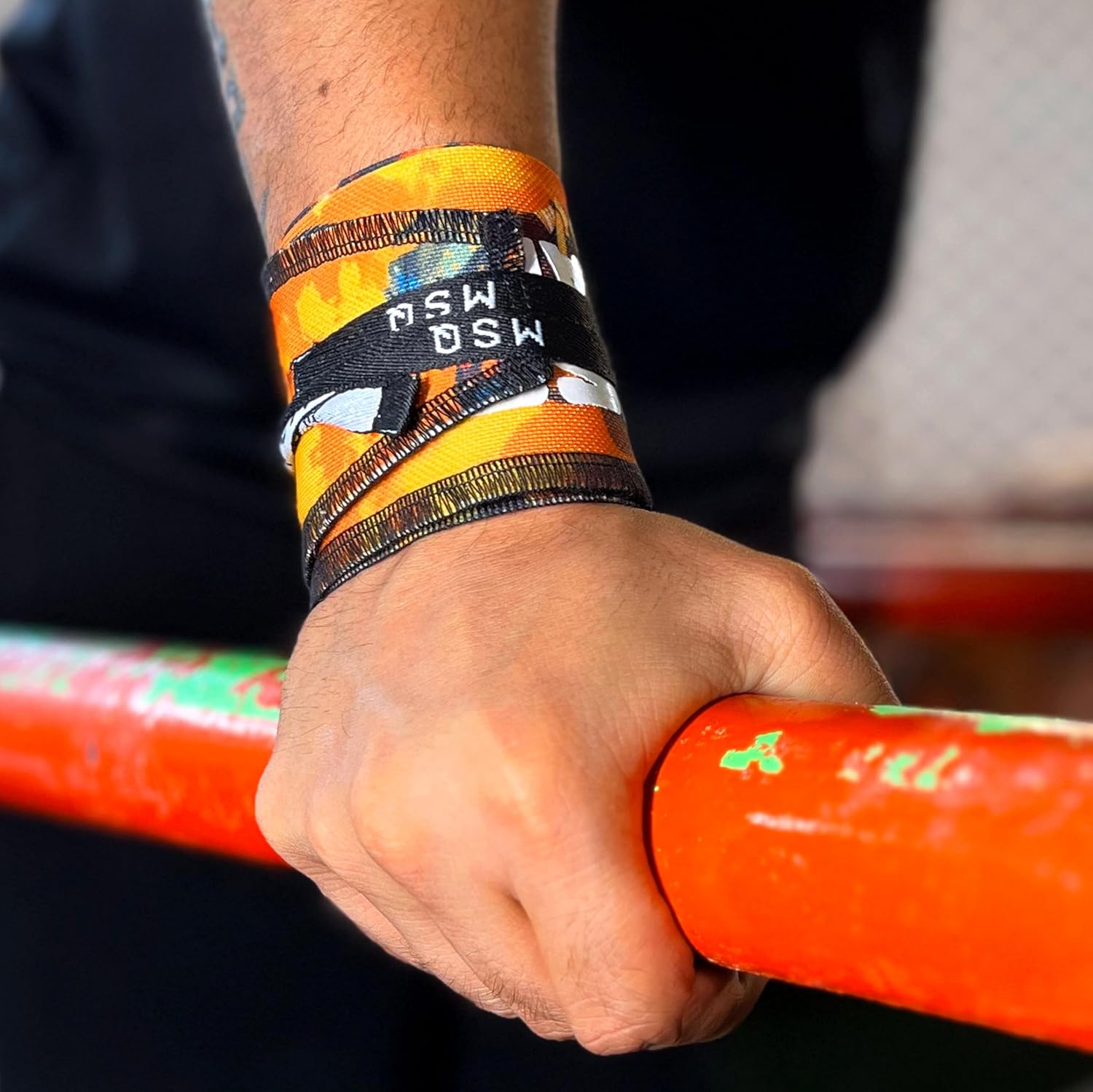 Close-up of a hand wearing Gripzora Power Weave wrist wraps, providing crucial stability and support during heavy lifts and calisthenics training.