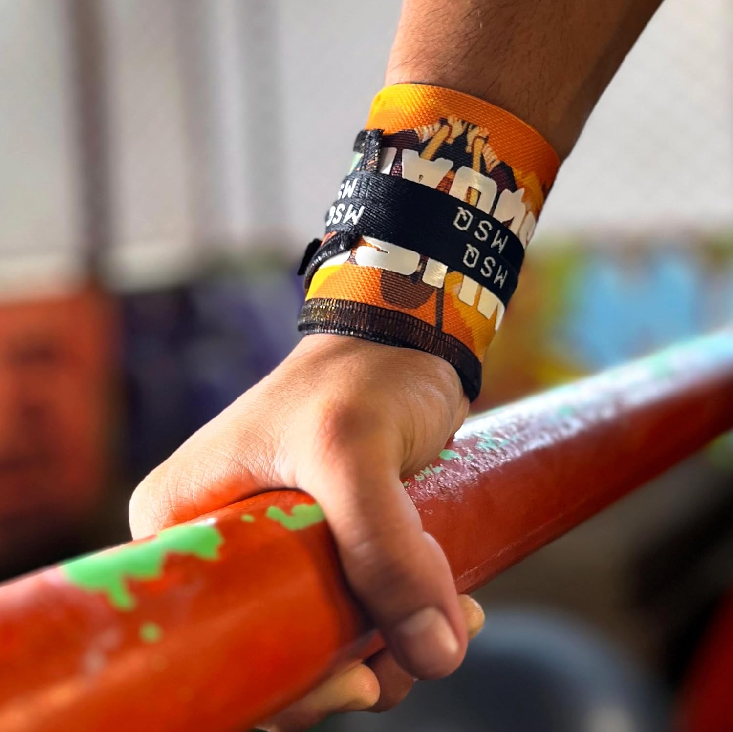 Close-up of a hand gripping a pull-up bar, wearing Gripzora Power Weave calisthenics wrist wraps for enhanced stability and injury prevention.