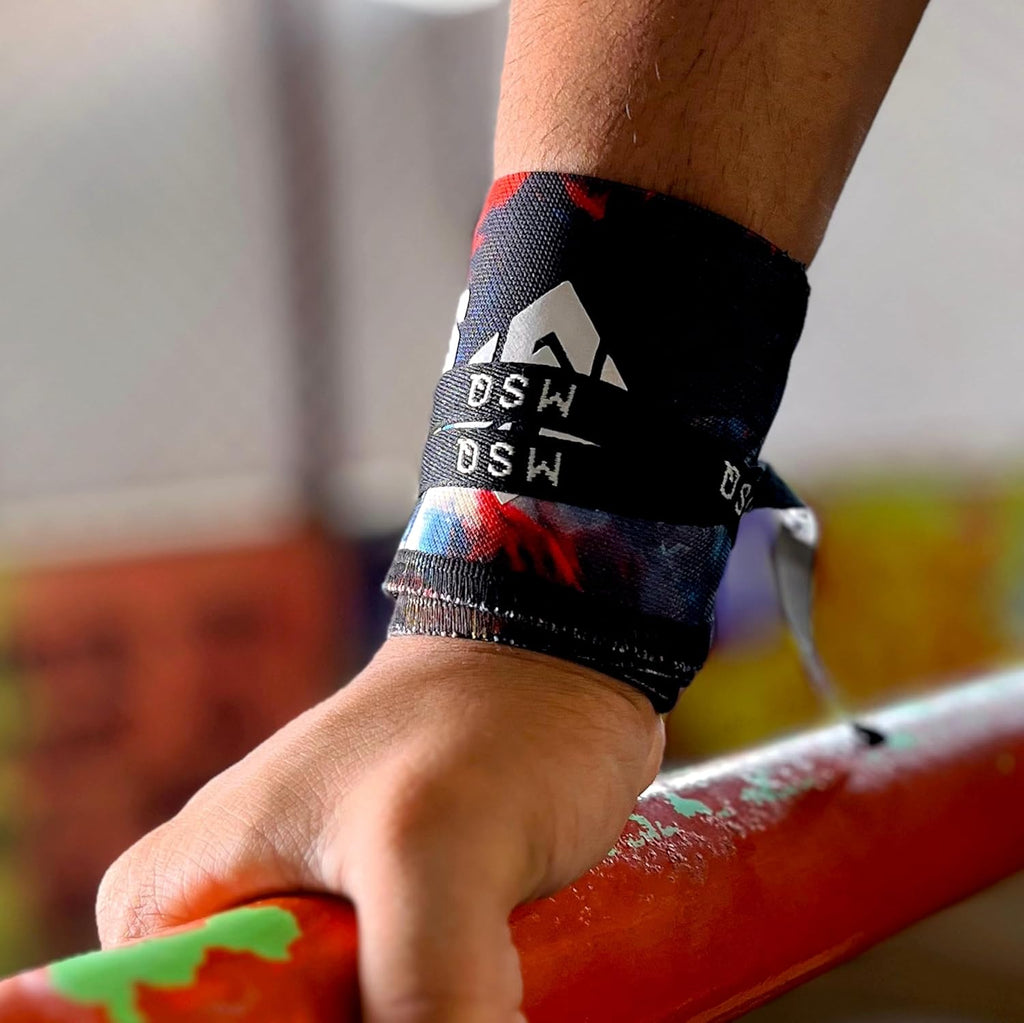 Close-up of a hand gripping a pull-up bar, wearing Gripzora Rogue Graffiti calisthenics wrist wraps for enhanced stability and injury prevention.