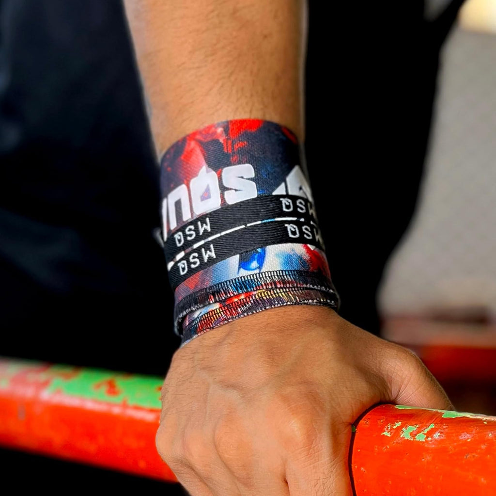 Close-up of a hand wearing Gripzora Rogue Graffiti wrist wraps, providing crucial stability and support during heavy lifts and calisthenics training.