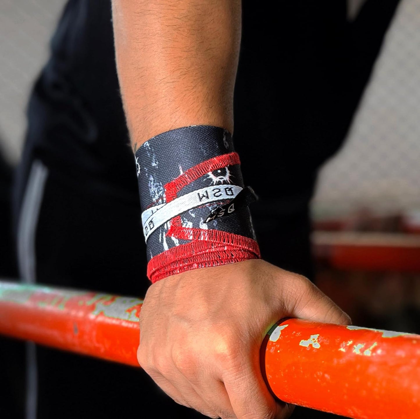 Close-up of a hand gripping a pull-up bar, wearing Gripzora Lunar Phase calisthenics wrist wraps for enhanced stability and injury prevention.