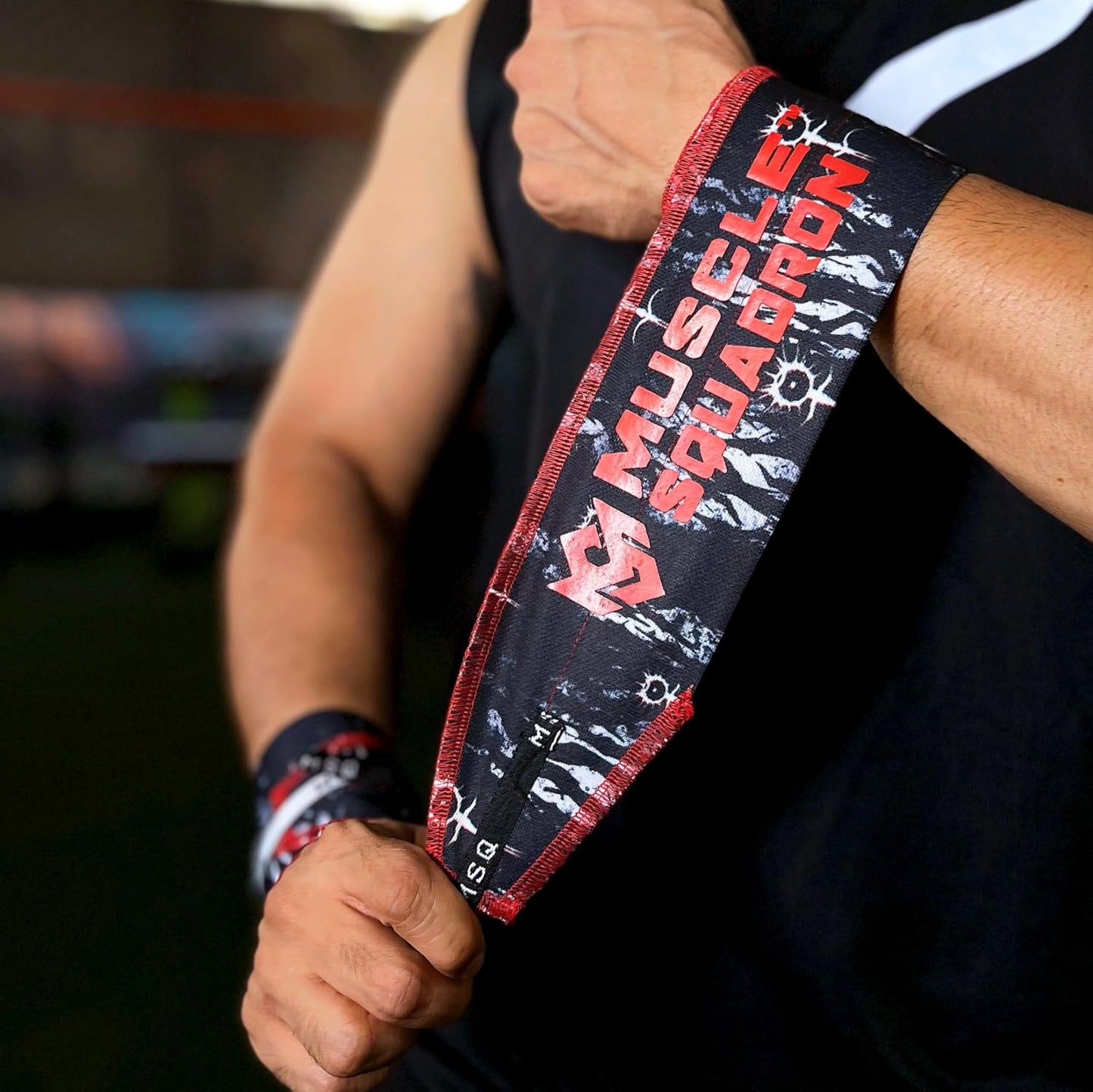 Close-up of a man's wrist, showing Gripzora's Lunar Phase wrist wraps providing firm stability and support during a workout.