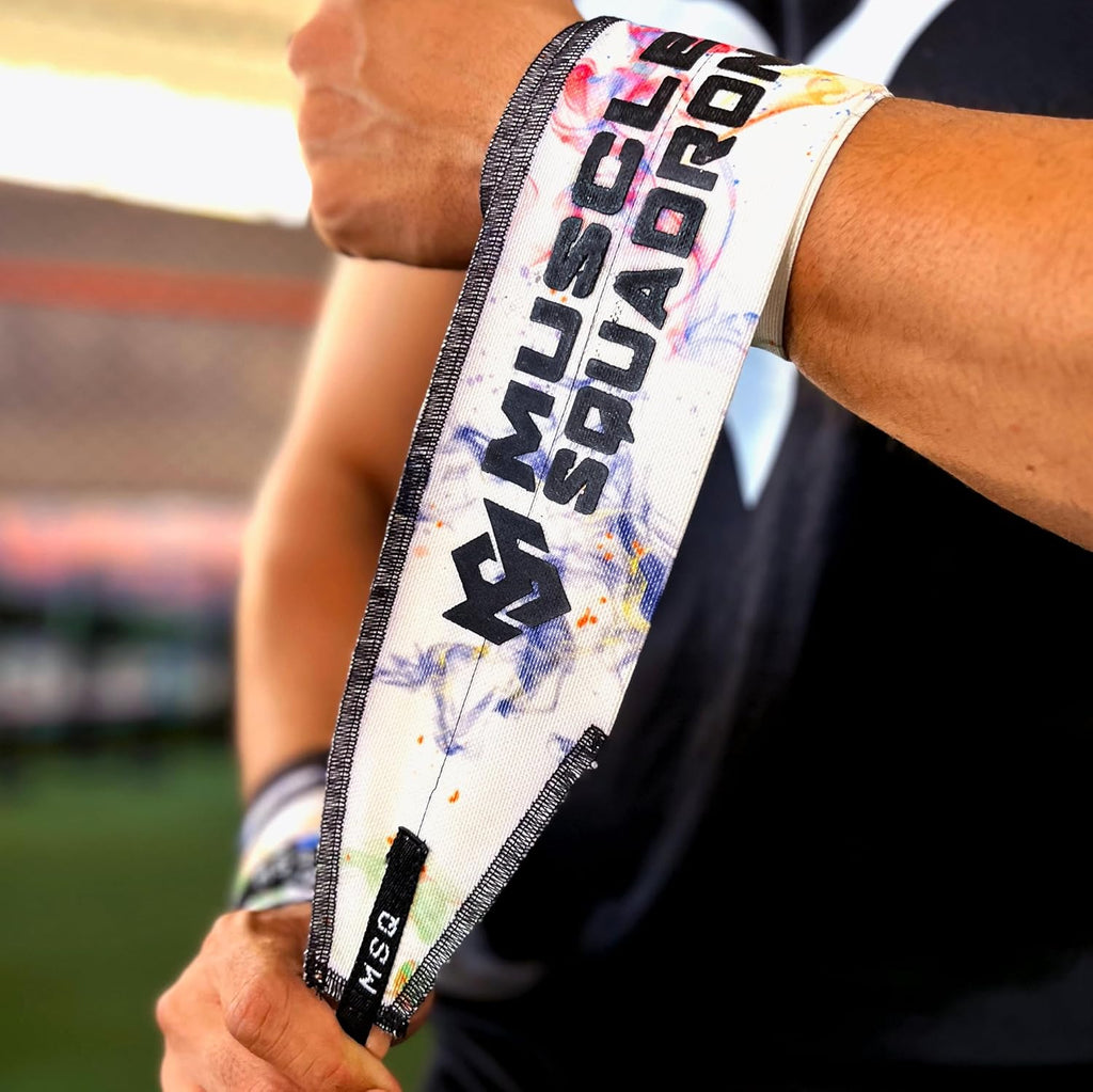 Close-up of a man's wrist, showing Gripzora's Galaxy Bloom wrist wraps providing firm stability and support during a workout.