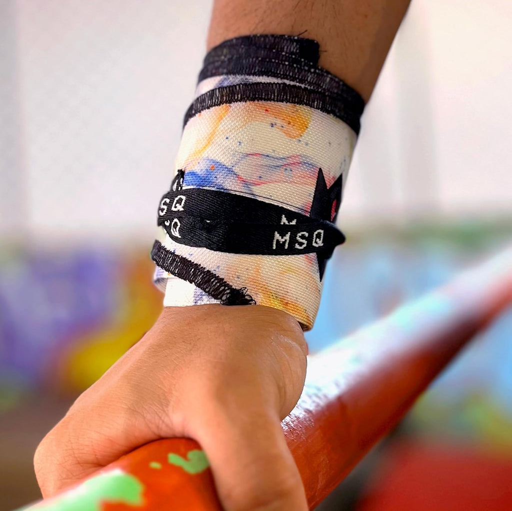 Close-up of a hand wearing Gripzora Galaxy Bloom wrist wraps, providing crucial stability and support during heavy lifts and calisthenics training.