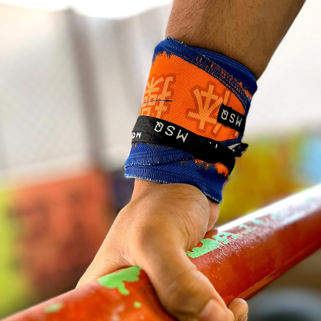 Close-up of a hand gripping a pull-up bar, wearing Gripzora Thunderball calisthenics wrist wraps for enhanced stability and injury prevention.